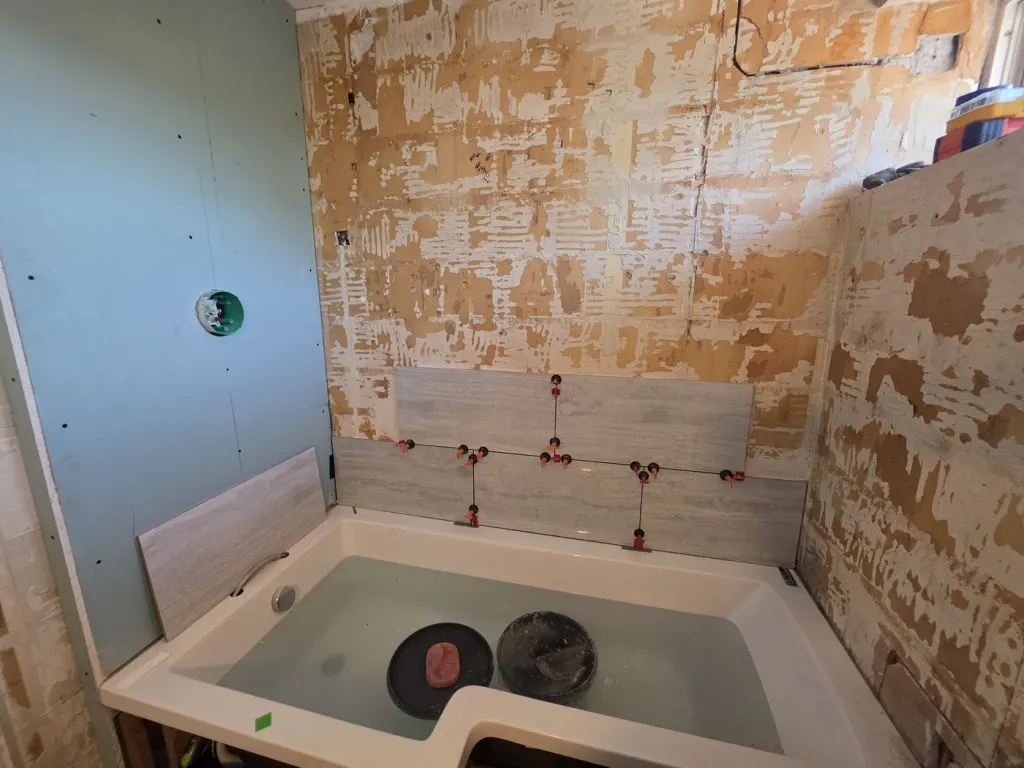 Before: Grey-tiled family bathroom