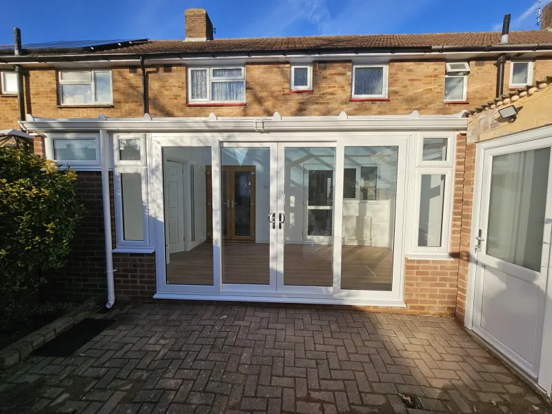 New white conservatory at the back of a house (photo 1)